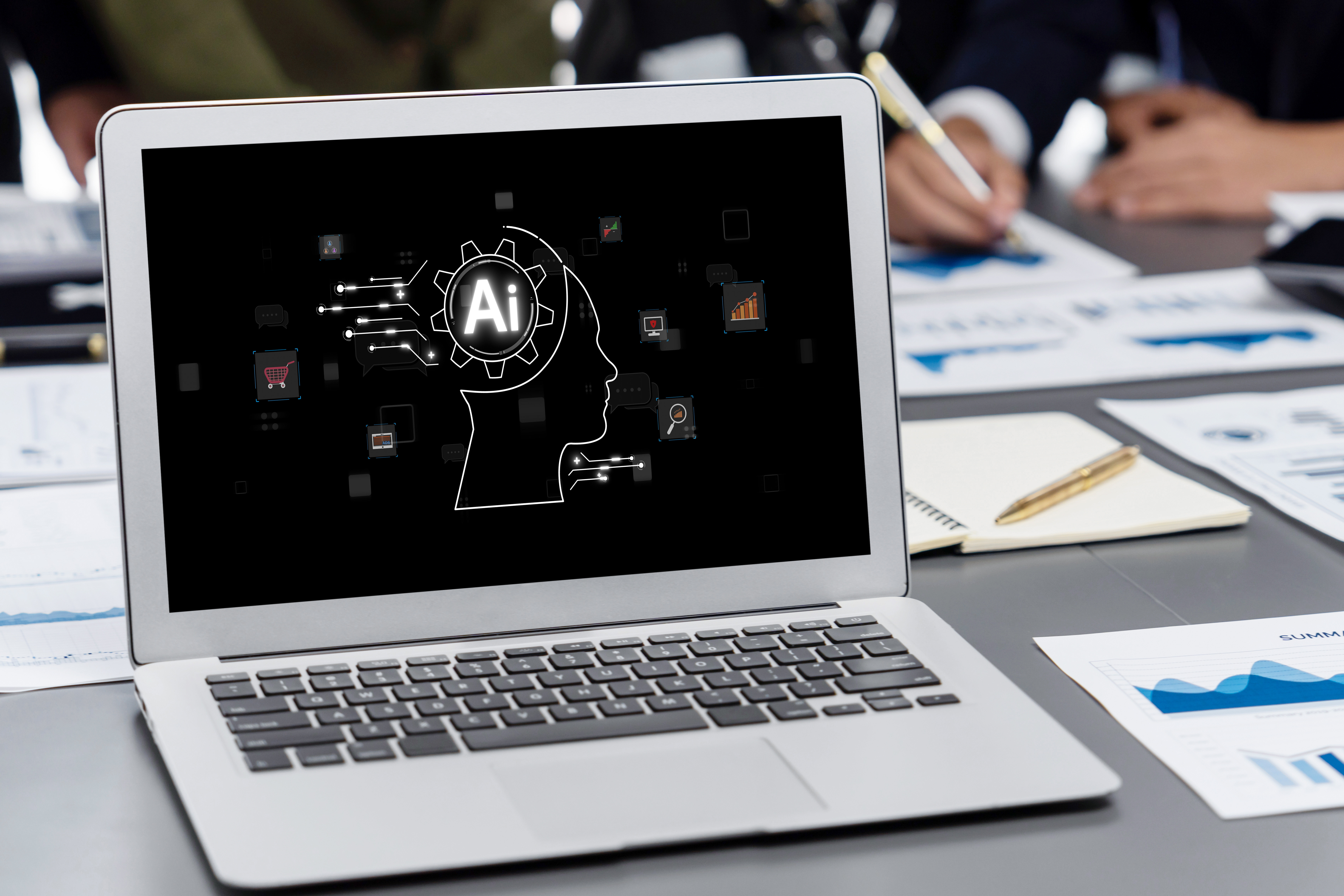 Decisions makers with work papers sitting at a table with a laptop computer that has an AI image on the screen.