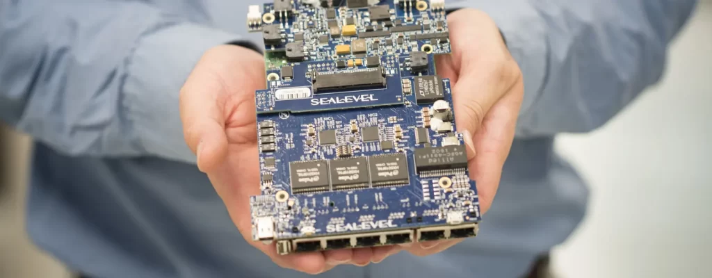 Sealevel engineer holding an industrial ethernet circuit board