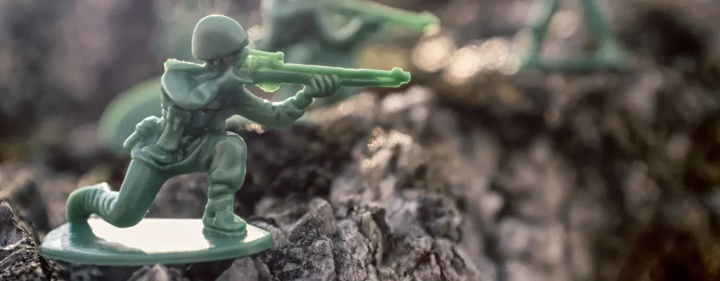 Green toy soldiers in natural outdoor environment