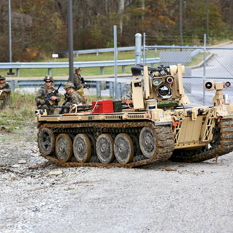 an unmanned ground vehicle with several soldiers of a ground force
